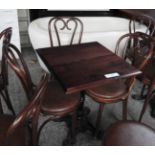 A set of three pub tables on cast iron bases with Andy Thornton bentwood chairs
