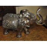 A silvered composite model of an elephant with mirrored inserts