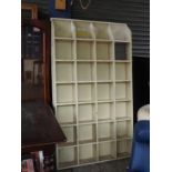 A large wooden pigeon hole storage unit with 28 slots