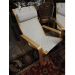 A pair of contemporary desiner lounger armchairs,