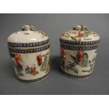 A pair of Chinese style lidded vases with pictorial detail