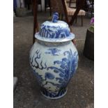 A pair of Chinese style blue and white vases with lids (one as found).