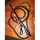 Two short leather whips and a larger leather plaited whip (3)