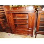 An early 20th Century German oak side cabinet having an arrangement of shelves to the front and