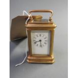 A miniature brass carriage clock