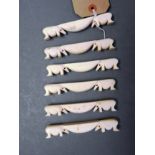 An early 20th Century set of six ivory cutlery rests with elephant finials