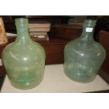 A pair of Venetian style green glass carboys (2)