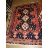 An antique Persian qashgai rug, the central ivory pole ,