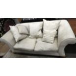 A contemporary two seater sofa upholstery in cream fabric