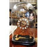 A large brass skeleton clock on plinth base within 19th Century style domed glass case