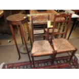 A pair of early 20th century country side chairs having rush seats,