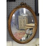 A small gilt oval wall hanging mirror