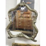 An antique white metal dressing mirror