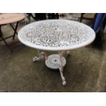 A white painted wrought iron style garden table