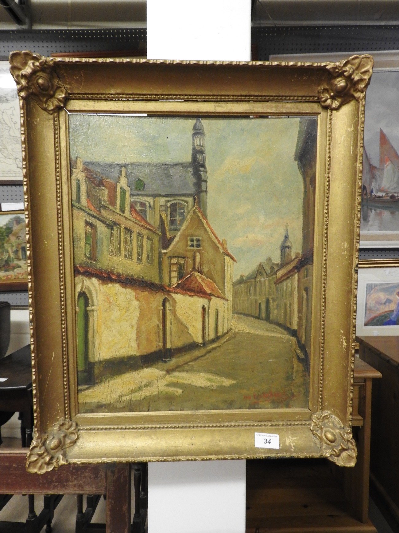 A 20th Century oil on board of a street scene in gilt frame