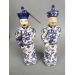 A pair of porcelain blue and white figures of chinamen H.