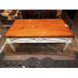A French fruitwood low table on a white painted base and tapered fluted supports