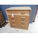 A 1930s oak chest of four long drawers raised on a plinth base.