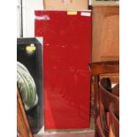 A contemporary red lacquered cupboard