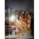 A large mounted photograph of Tokyo street scene at night