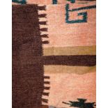 A handmade contemporary Aztec design rug,