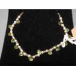 A 14k gold seed pearl and peridot necklace