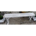 A white painted bowling green bench.
