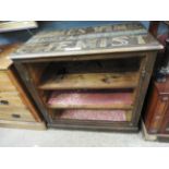 An early 20th century stained pine, shop open display case, having printed lettering to the top,