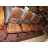 A set of four early 20th Century carved oak dining chairs,