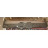 A Victorian black painted cast iron fire surround with pierced decoration and two central roundels,