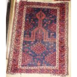 An antique signed Afghan design rug of small proportions,
