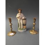 A Staffordshire figure of a sailor and a pair of 19th Century petal candlesticks