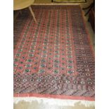 A Bokhara rug on a red ground, geometric design with ghoul motifs.