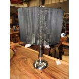 A contemporary designer French chrome centre table lamp having oversized black silk shade and glass