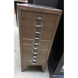 A vintage short metal filing cabinet, having ten drawers with a small label marked H.J.