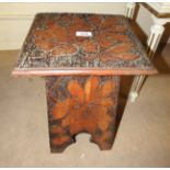 A folk art oak occasional table, having oak lead decoration,