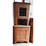 A pine two section corner cabinet with glazed top over panel, doors on.