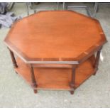 A Georgian design John Lewis mahogany and crossbanded octagonal two tiered low table raised on