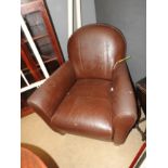 A contemporary brown leather stitched club armchair