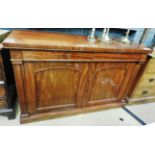 A mahogany sideboard with two drawers over panel doors on plinth base