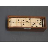 A cased set of early 20th Century ivory dominoes