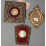 A pair of plaques with central portraits and a gilt mirror