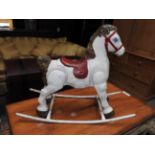 A 1950s tin triang style Mobo rocking horse.