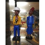 A pair of African Colonial painted figural models in vibrant colours (2)