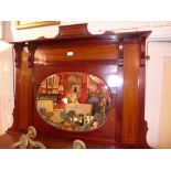 An Edwardian inlaid mahogany overmantel mirror with oval bevelled plate.