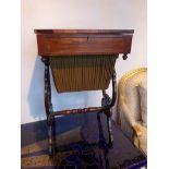 A William IV rosewood work table having rising lid and fitted interior raised on tulip shaped