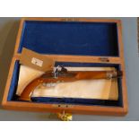 A cased Boosey and Hawkes Emperor flute and a walnut percussion pistol.