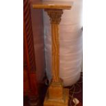 An onyx jardiniere stand of Corinthian column form and with gilt metal embellishments.