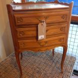 A French beached walnut bedside chest fitted three drawers and raised on cabriole supports.
