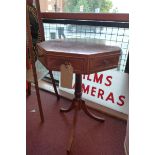 An inlaid flame mahogany octagonal top lamp table fitted two drawers raised on triform supports.
